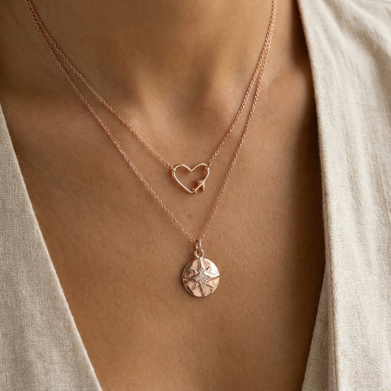Luna Dura Embrace universally flattering style with these delicate rose gold layered heart and rhinestone compass necklaces on warm olive skin UAE.