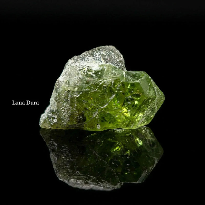 Natural peridot rough crystal macro detail showing translucent green interior and uncut mineral surface, Luna Dura Dubai gemologist