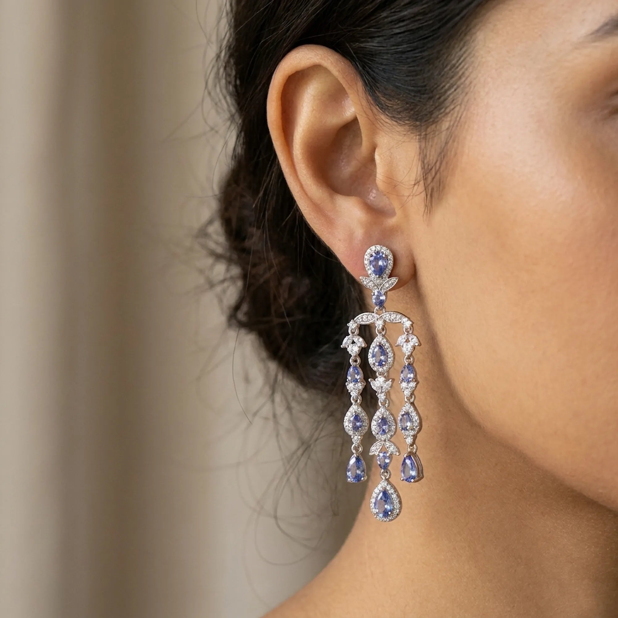 Natural tanzanite chandelier earrings in 925 sterling silver worn with a black abaya, December birthstone jewellery handcrafted in Dubai by Luna Dura.