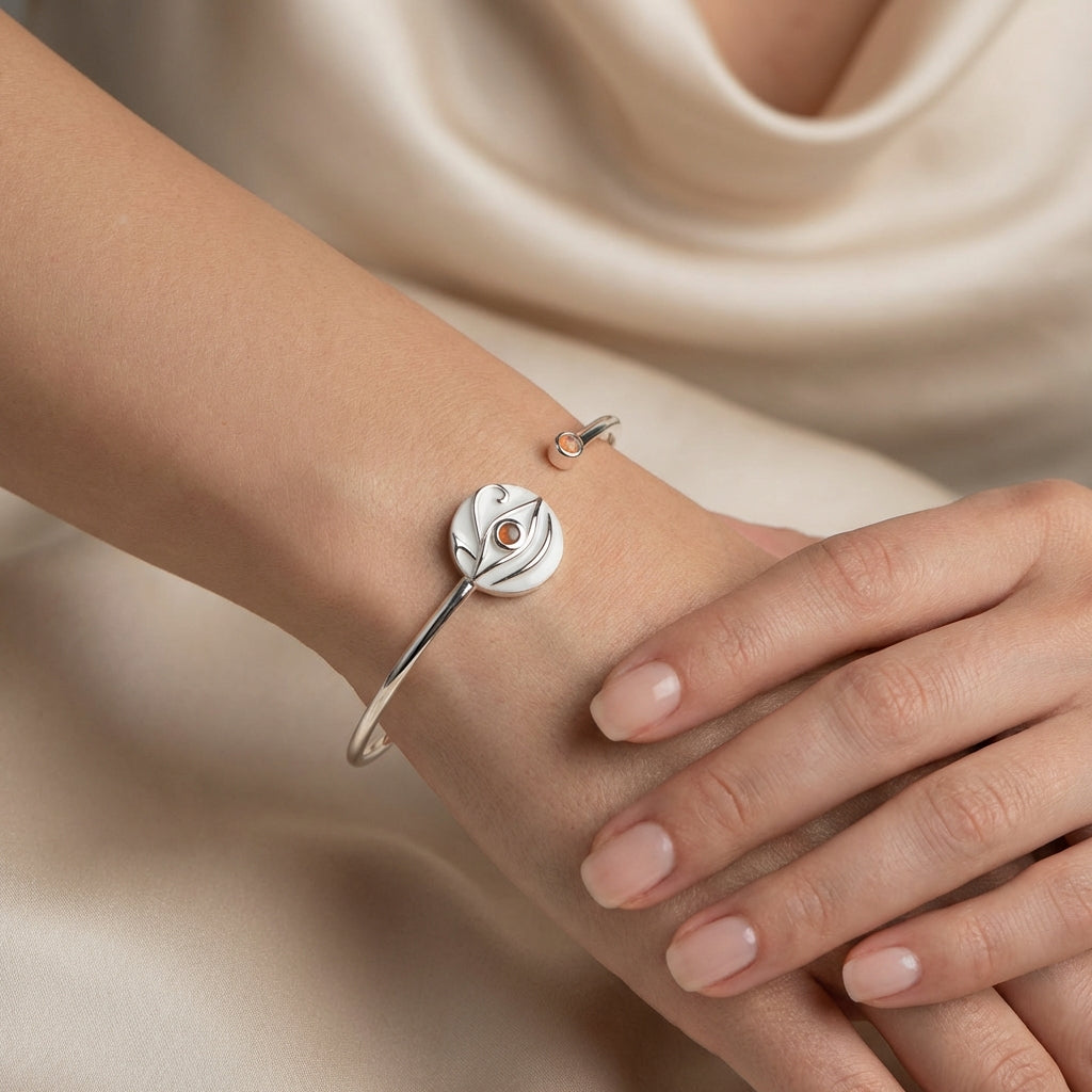 Close up of an elegant woman wearing a premium 925 silver cuff bracelet featuring white enamel detailing, showcasing luxury statement jewelry from Luna Dura Dubai.