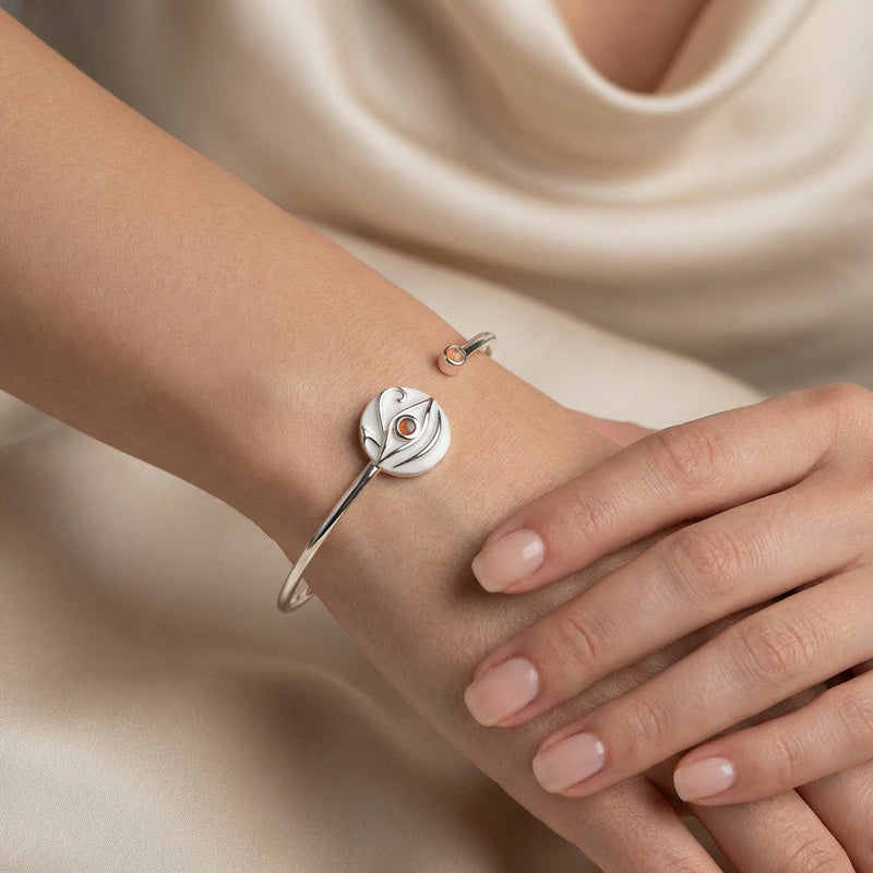 Close up of an elegant woman wearing a premium 925 silver cuff bracelet featuring white enamel detailing, showcasing luxury statement jewelry from Luna Dura Dubai.