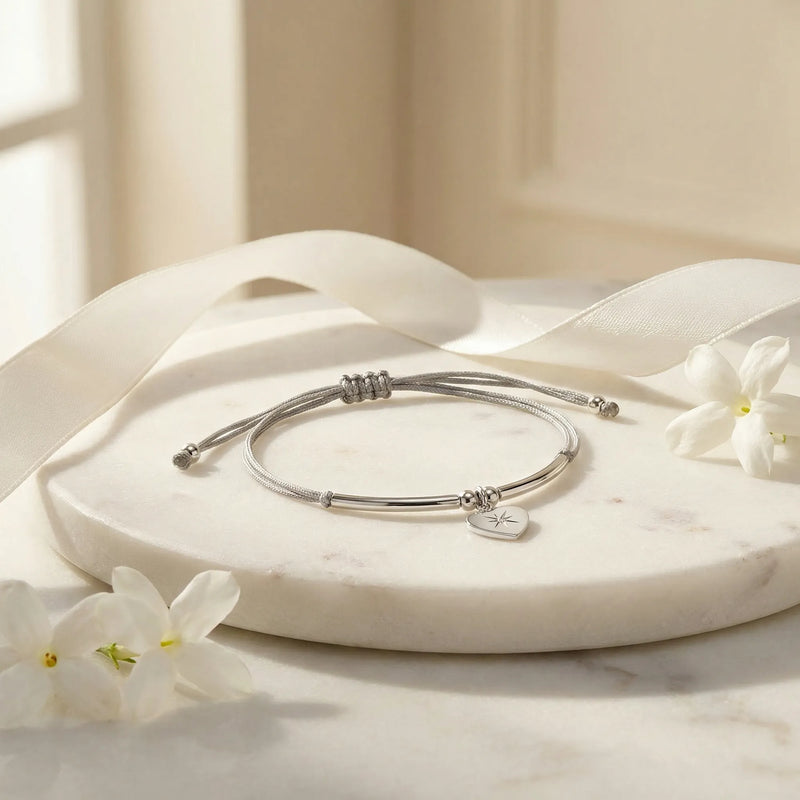 North Star heart silver bracelet flatlay on marble with jasmine and ribbon, gift-ready, Luna Dura Dubai