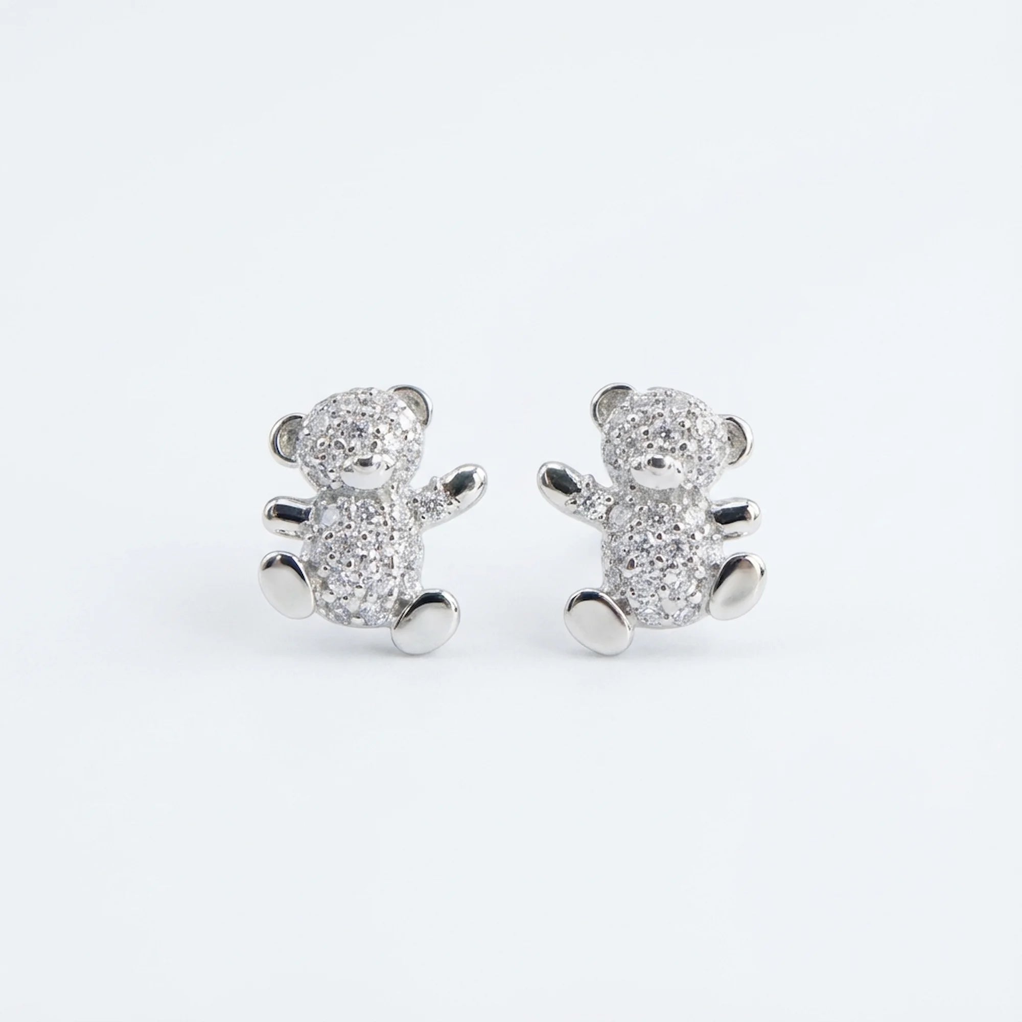 925 silver teddy bear stud earrings isolated on a white background in a Dubai studio.