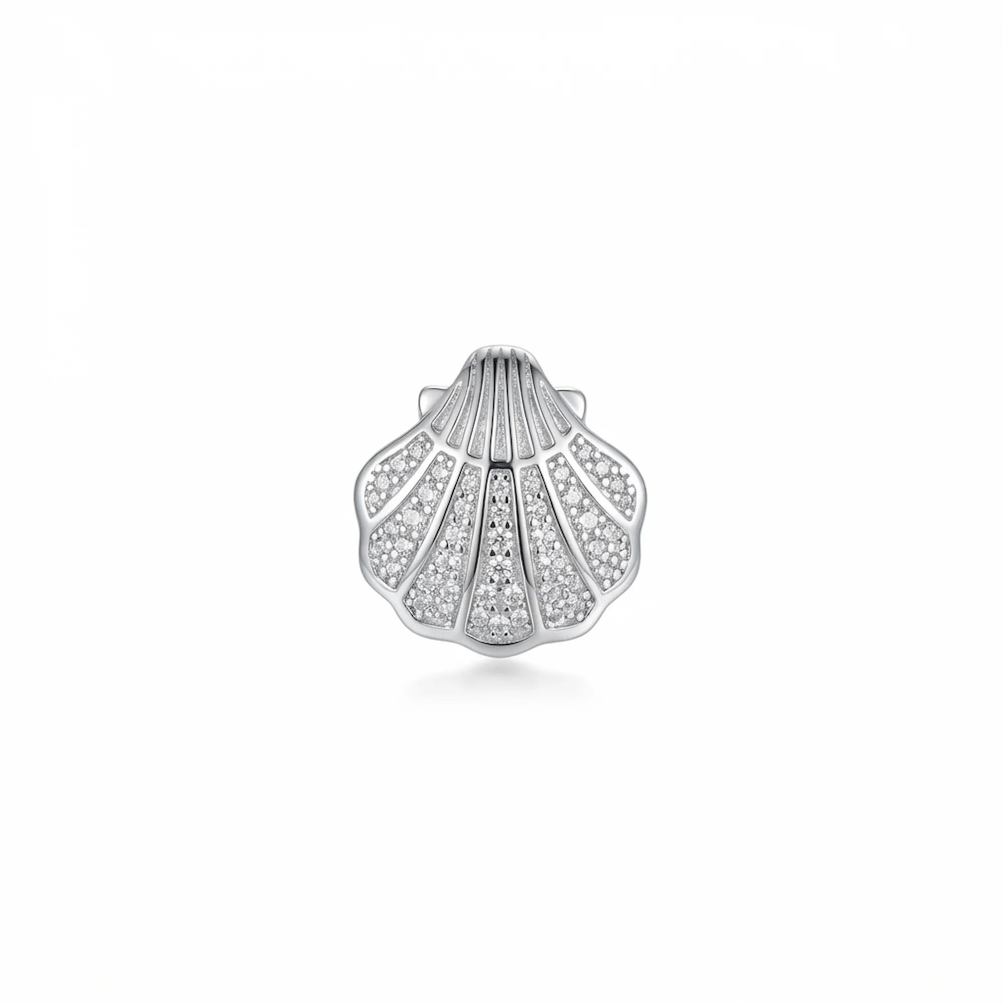Close-up of a single silver shell ear stud featuring handset cubic zirconia detailing.
