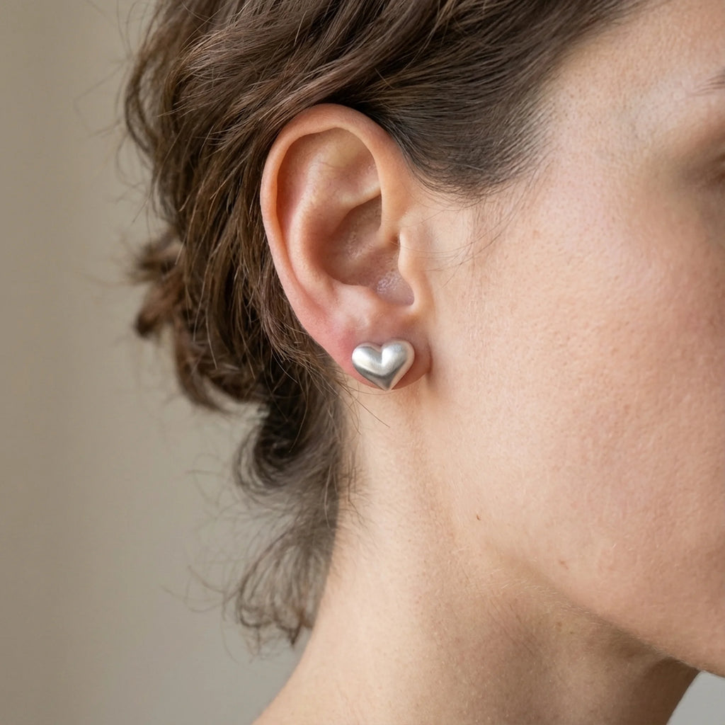 Elegant woman wearing 925 silver heart studs in Dubai