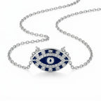 Silver necklace with a blue and white eye-shaped pendant on a white background