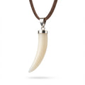 Tusk-shaped pendant on a brown cord against a white background in Dubai.