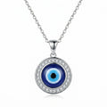 Silver necklace with blue glass evil eye pendant and white cubic zirconia detailing