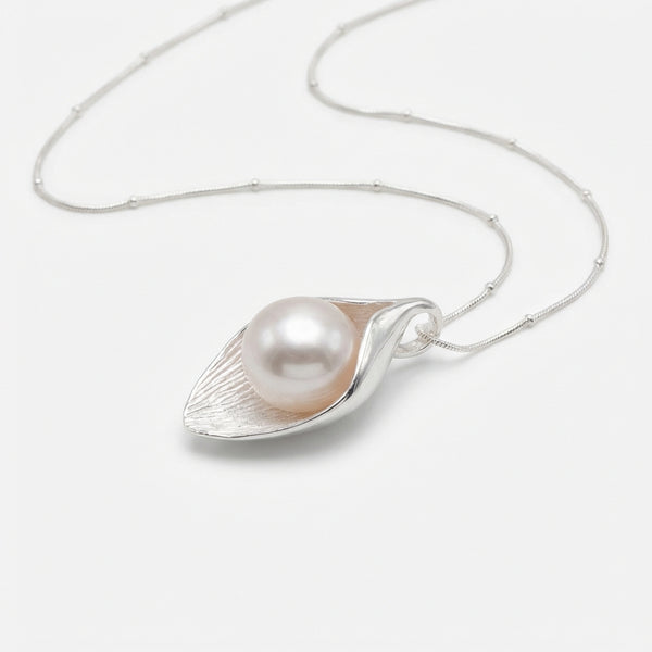 Pearl pendant in Dubai on a silver chain against a white background