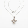 Cupid Necklace with a faux pearl pendant and silver angel wings on a white background