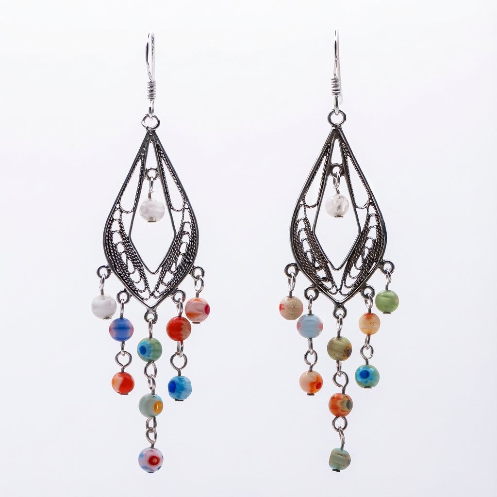 Pair of chandelier earrings with intricate designs and colorful Morano glass beads on a white background