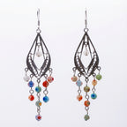 Pair of chandelier earrings with intricate designs and colorful Morano glass beads on a white background
