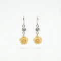 Pair of earrings with rose-shaped charms in Dubai on a white background.