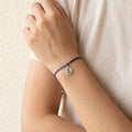 Navy cord bracelet in Dubai with hammered silver disc anchor charm, nautical minimalist design Arabic.
