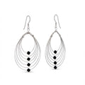 Pair of silver earrings in Dubai with black beads on a white background.