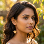 Model wearing Yellow Carnelian flower drop earrings — hand-carved honey-yellow quartz blossoms with amber-tone crystal beads in 925 sterling silver, designed in Dubai.