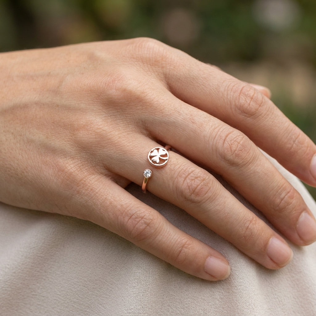 model wearing a ring with a clover design and small cubic zirconia  gemstone on a blurred natural background dubai 