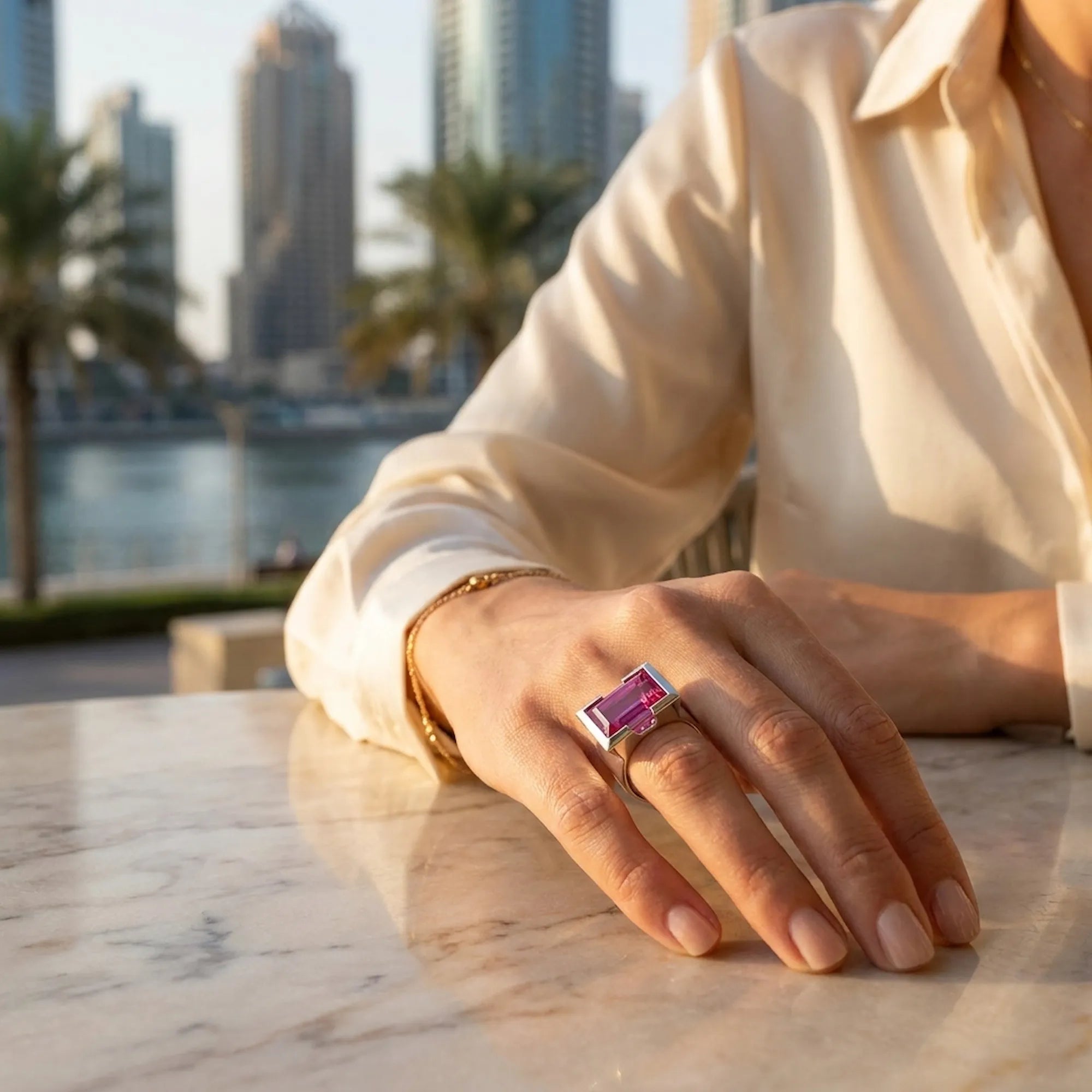 model Hand wearing a ring display size reference with JLT cityscape in the background