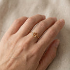 925 sterling silver ring with star and gemstone design on a hand against a neutral background uae
