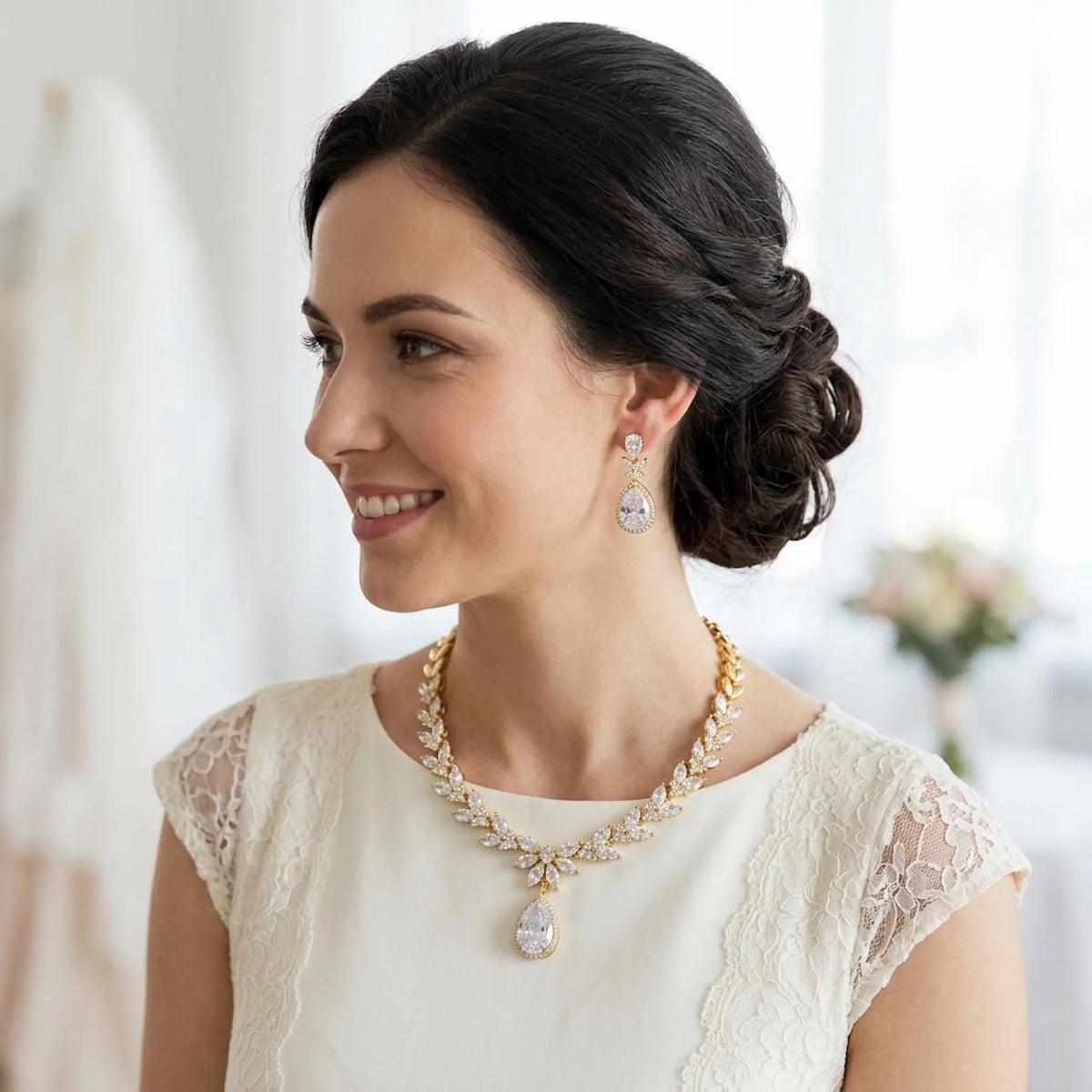 Bride wearing an 18k gold-plated cubic zirconia marquise foliage and halo teardrop necklace set indoors in Dubai.