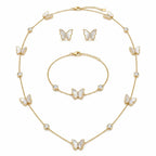 18K gold plated butterfly jewelry set with iridescent mother of pearl motifs and round cubic zirconia bezel accents.