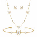 Close-up of 18K gold plated mother of pearl butterfly pendant with pave cubic zirconia center and bezel-set crystals.