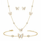 Close-up of 18K gold plated mother of pearl butterfly pendant with pave cubic zirconia center and bezel-set crystals.