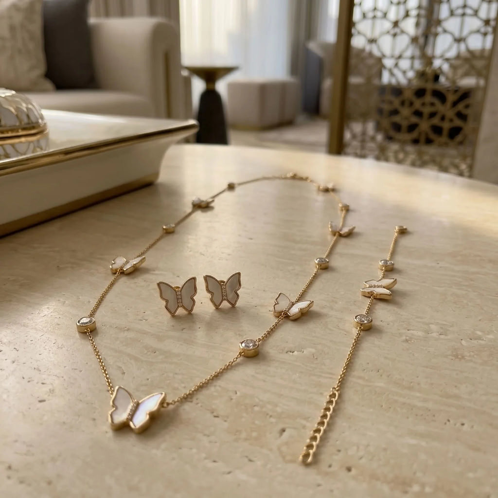 Extender chain and lobster clasp closure detail on 18K gold plated mother of pearl butterfly necklace and bracelet.