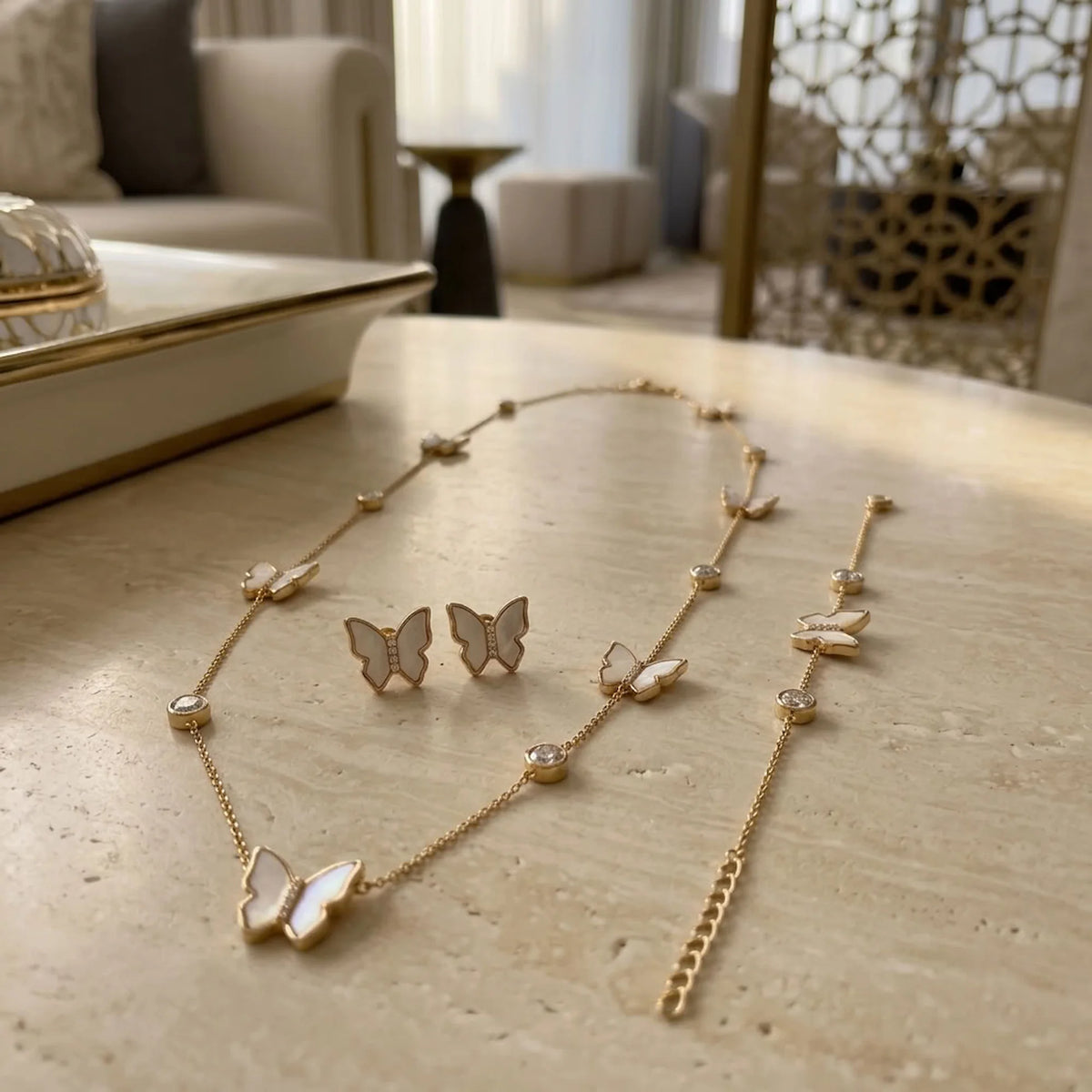 Extender chain and lobster clasp closure detail on 18K gold plated mother of pearl butterfly necklace and bracelet.