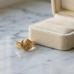 18K gold vermeil tulip medallion ring in 925 sterling silver resting beside a velvet jewellery box in Dubai.