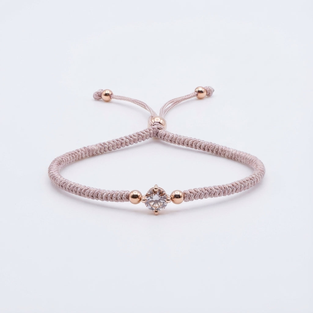 سوار من حبل الباراكورد بلون بيج رمادي مع قلب من الكريستال الذهبي الوردي