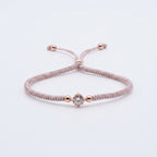 سوار من حبل الباراكورد بلون بيج رمادي مع قلب من الكريستال الذهبي الوردي