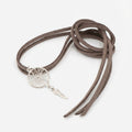 Brown suede necklace with a silver dreamcatcher pendant on a white background Dubai UAE.