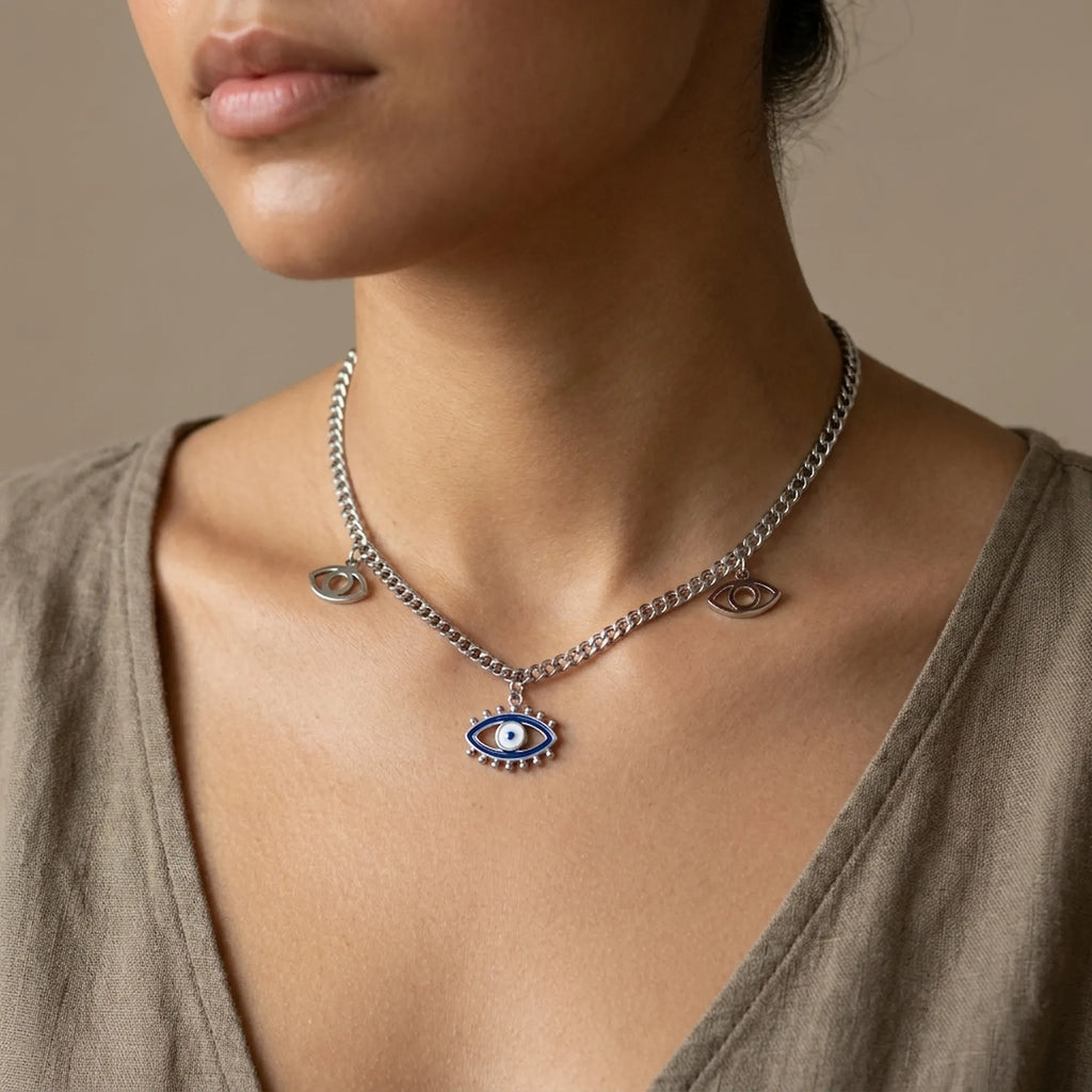 Necklace with an eye-shaped pendant worn by a model against a neutral background