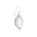 Silver earring with a large pearl-like stone on a white background in Dubai .