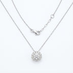 Silver necklace with a round pendant on a white background