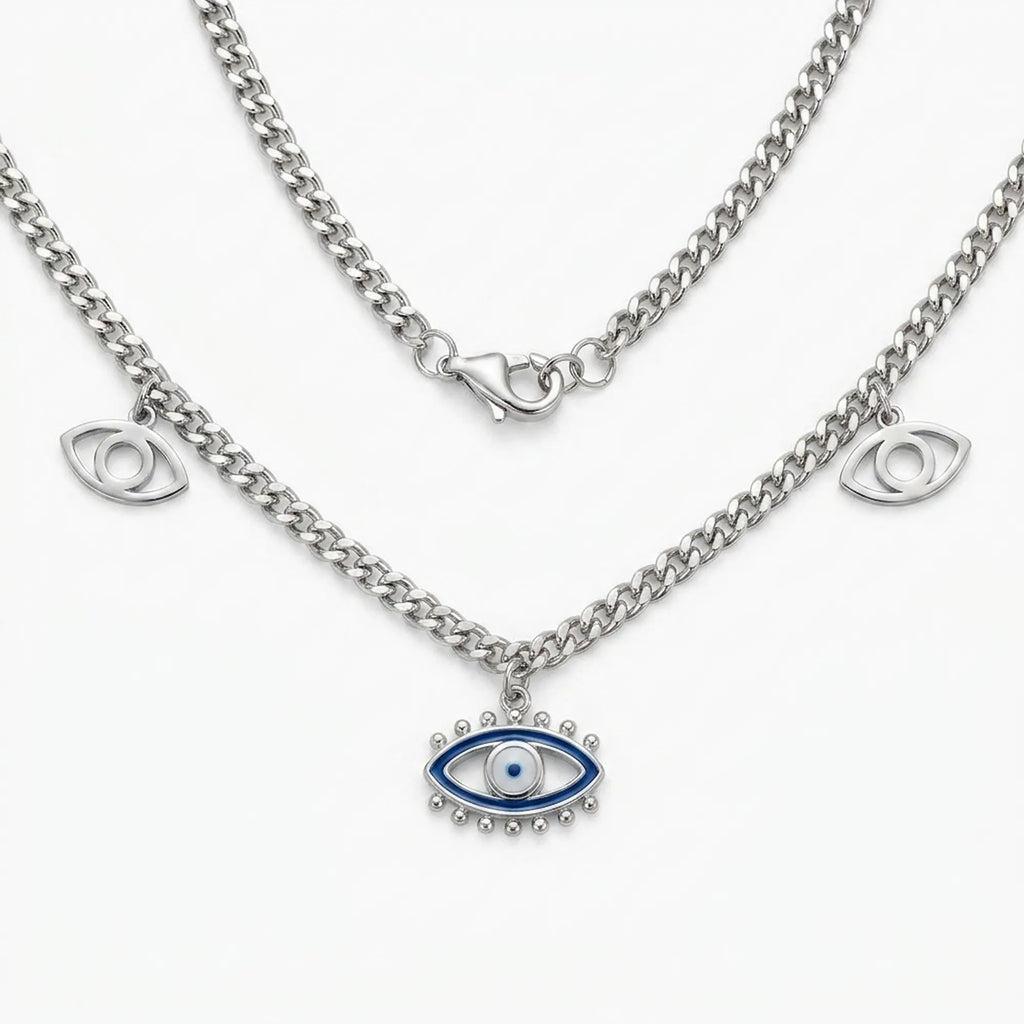 silver evil eye charm necklace with blue enamel center pendant and two side eye charms on a curb chain