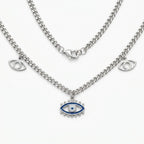 silver evil eye charm necklace with blue enamel center pendant and two side eye charms on a curb chain