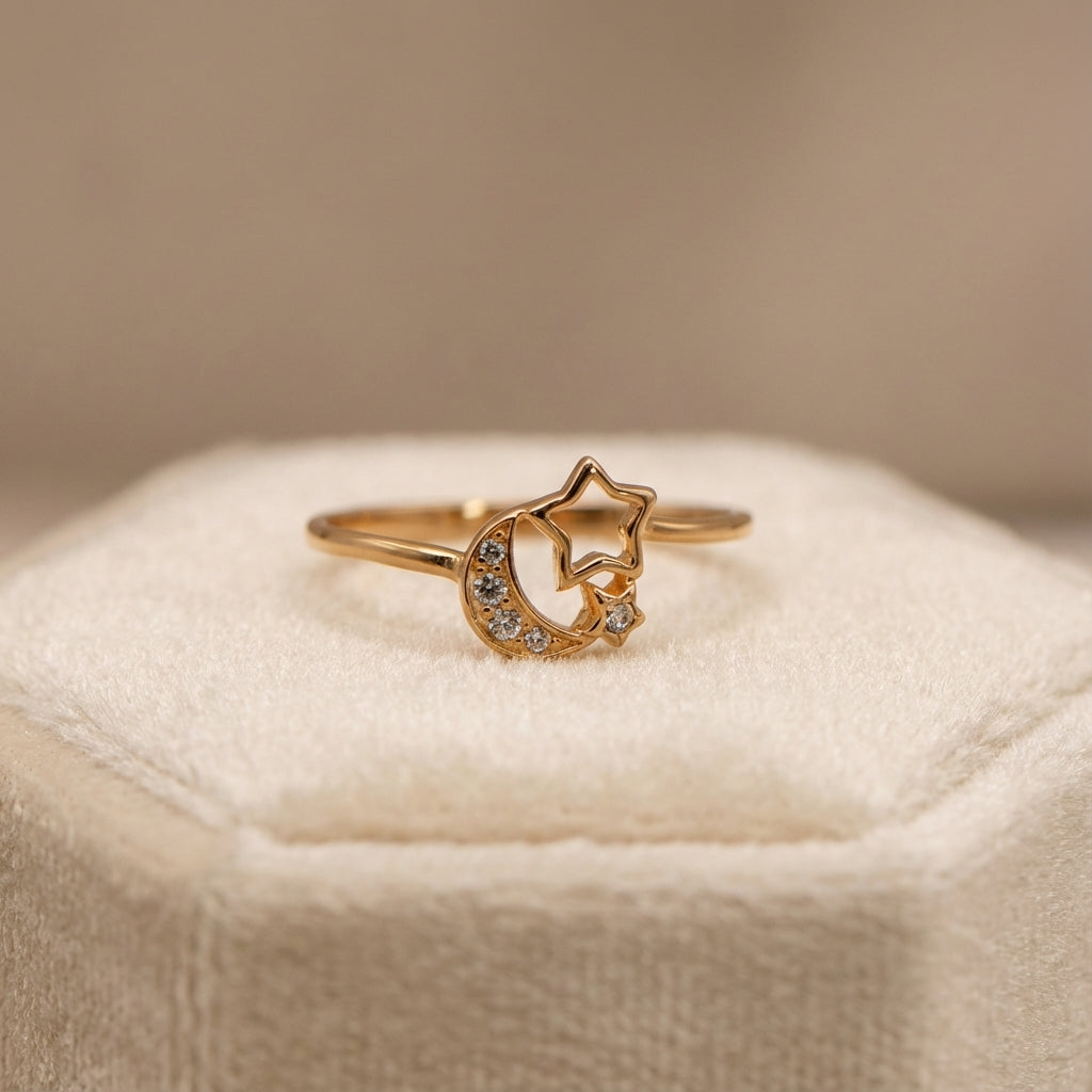 Gold ring with star and moon design on a soft beige surface dubai