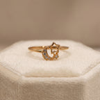 Gold ring with star and moon design on a soft beige surface dubai