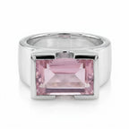 Silver ring with a pink gemstone on a white background