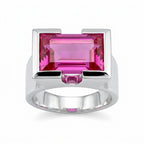 Silver ring with a magenta quartz gemstone on a white background