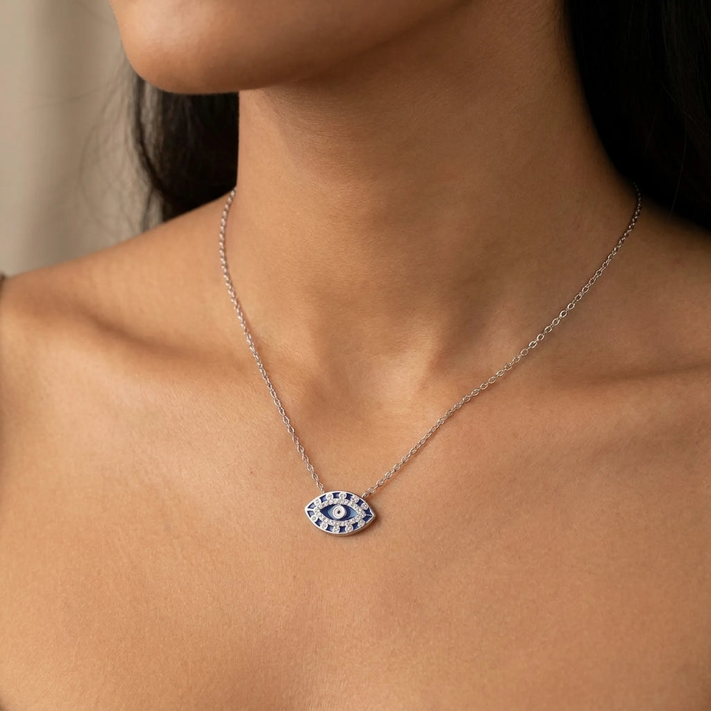 Necklace with a blue evil eye pendant worn by a model