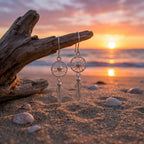 Silver earrings on Kite beach Dubai with a sunset in the background