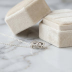 macro photo display the Silver necklace with a double heart-shaped  perforated in the top side of the heart pendant