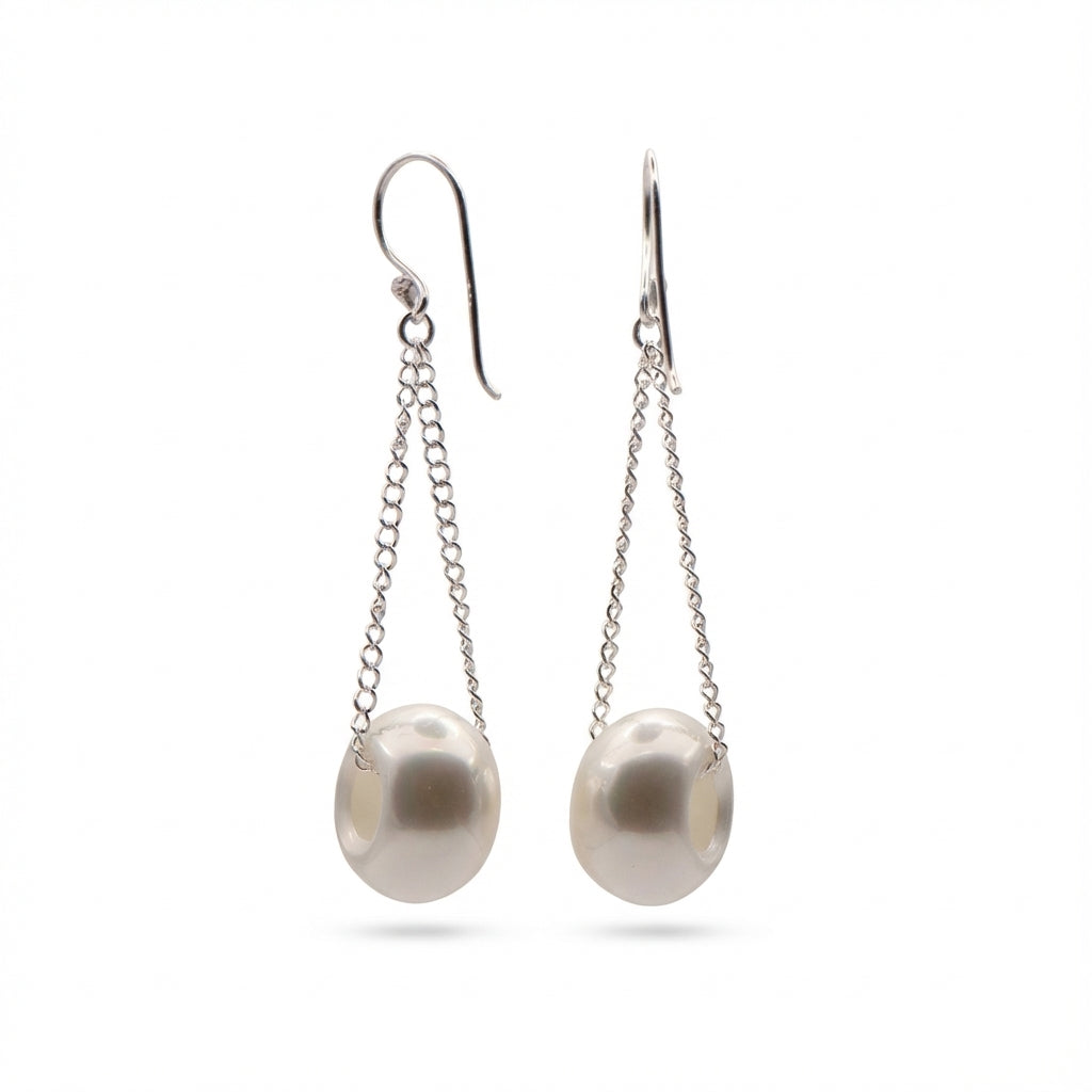 Pearl earrings with silver chains on a white background