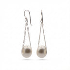 Pearl earrings with silver chains on a white background