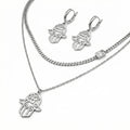 Silver Hamsa hand necklace in Dubai and earrings on a white background