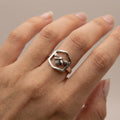 Female model wearing the handcrafted hexagon bee ring in oxidized 925 sterling silver — bee perched in honeycomb hexagon visible on the finger.design