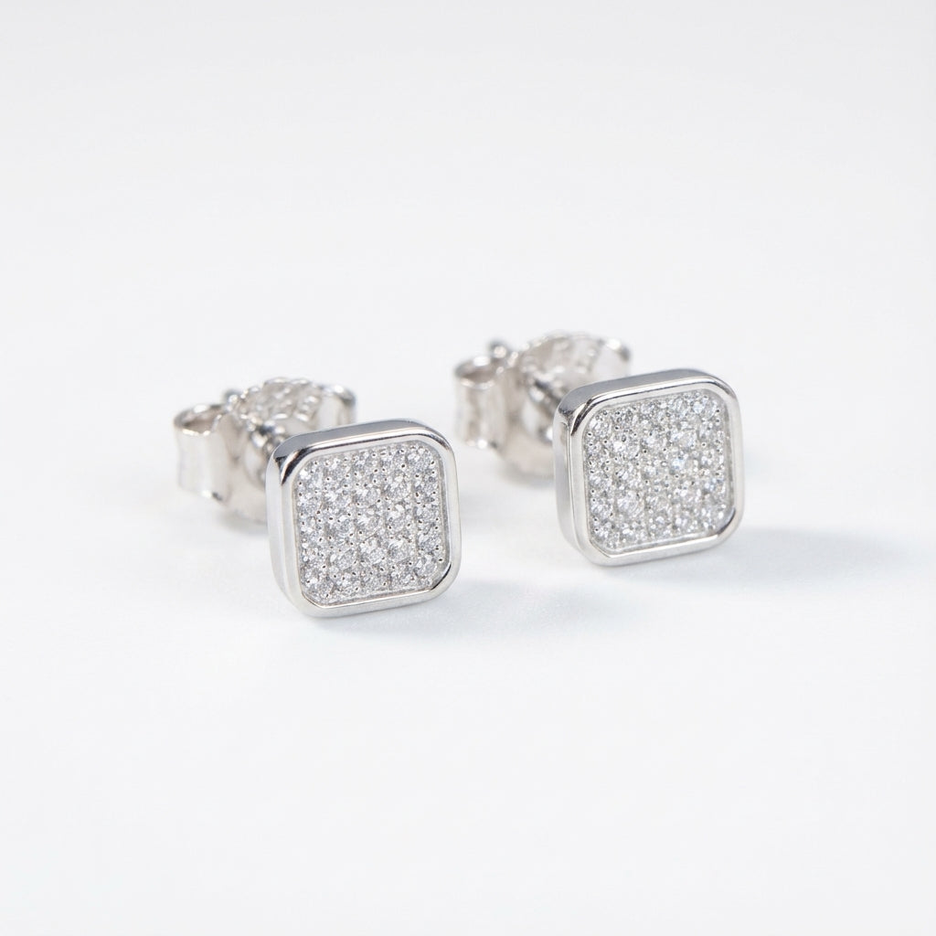 Silver square earrings with a glittery finish on a white background UAE